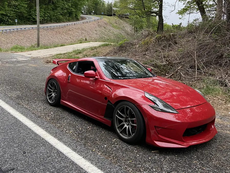 A red Nissan 370Z in the lot after paint work